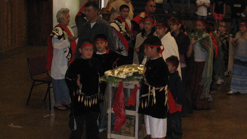 Honoring the gift of the First Salmon during the Ceremony Honoring the gift of the First Salmon, and passing along the wisdom of the elders to our children, during the Ceremony